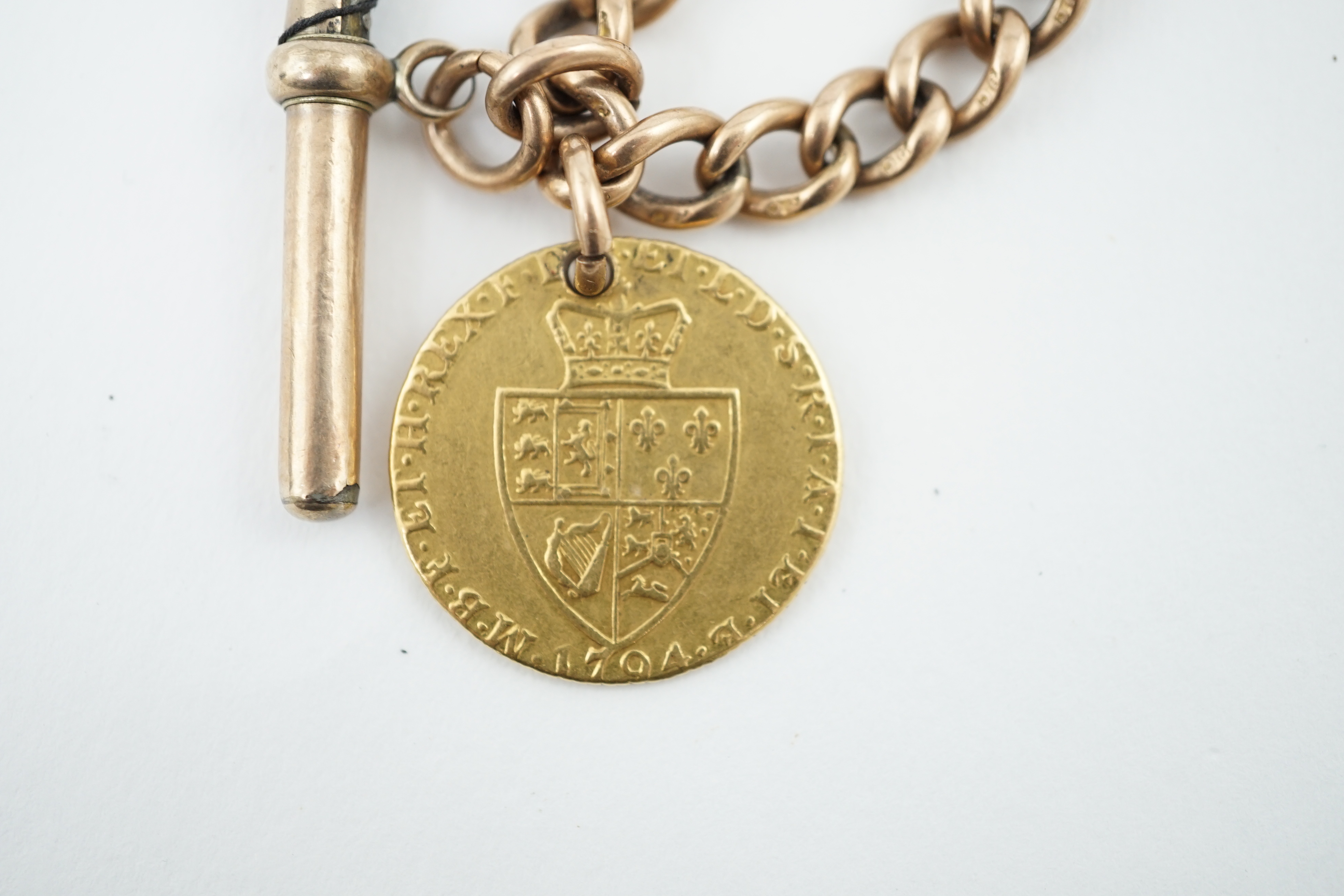 A 9ct gold albert, with gold plated T-bar and hung with a George III 1794 gold spade guinea